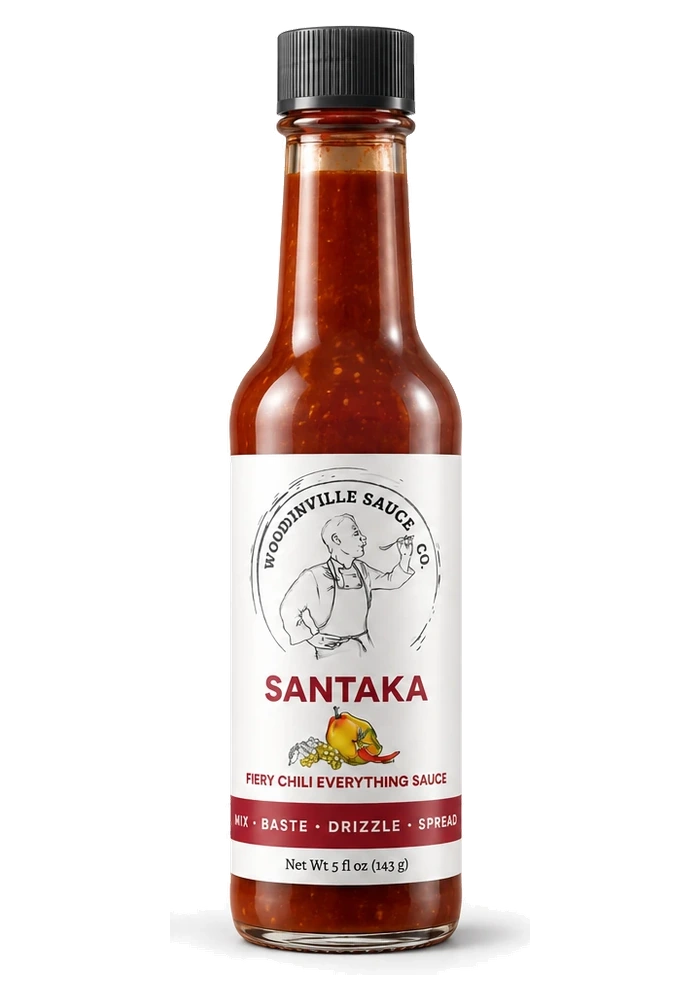 Santaka_standard_web - Woodinville Sauce Co. Bottle of Santaka hot sauce by Woodinville Sauce Co. with a white label showing a cook illustration and a red pepper graphic